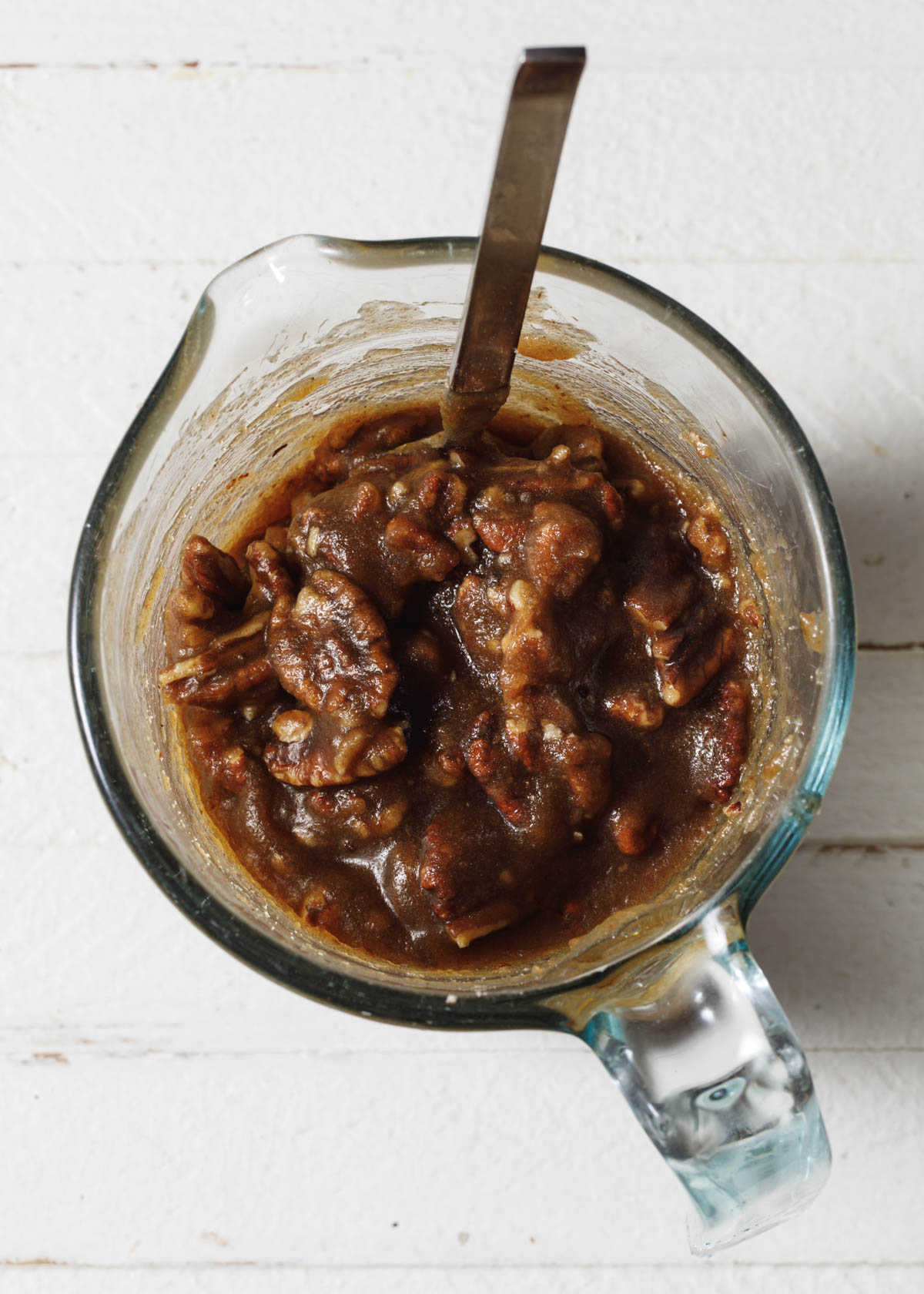 Pecan topping in a measuring cup