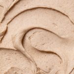 A close-up swirl of smooth cinnamon buttercream