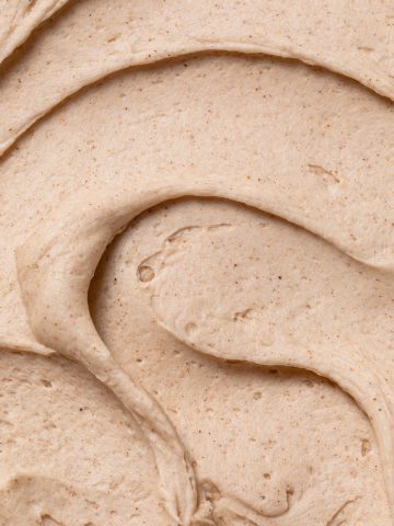 A close-up swirl of smooth cinnamon buttercream