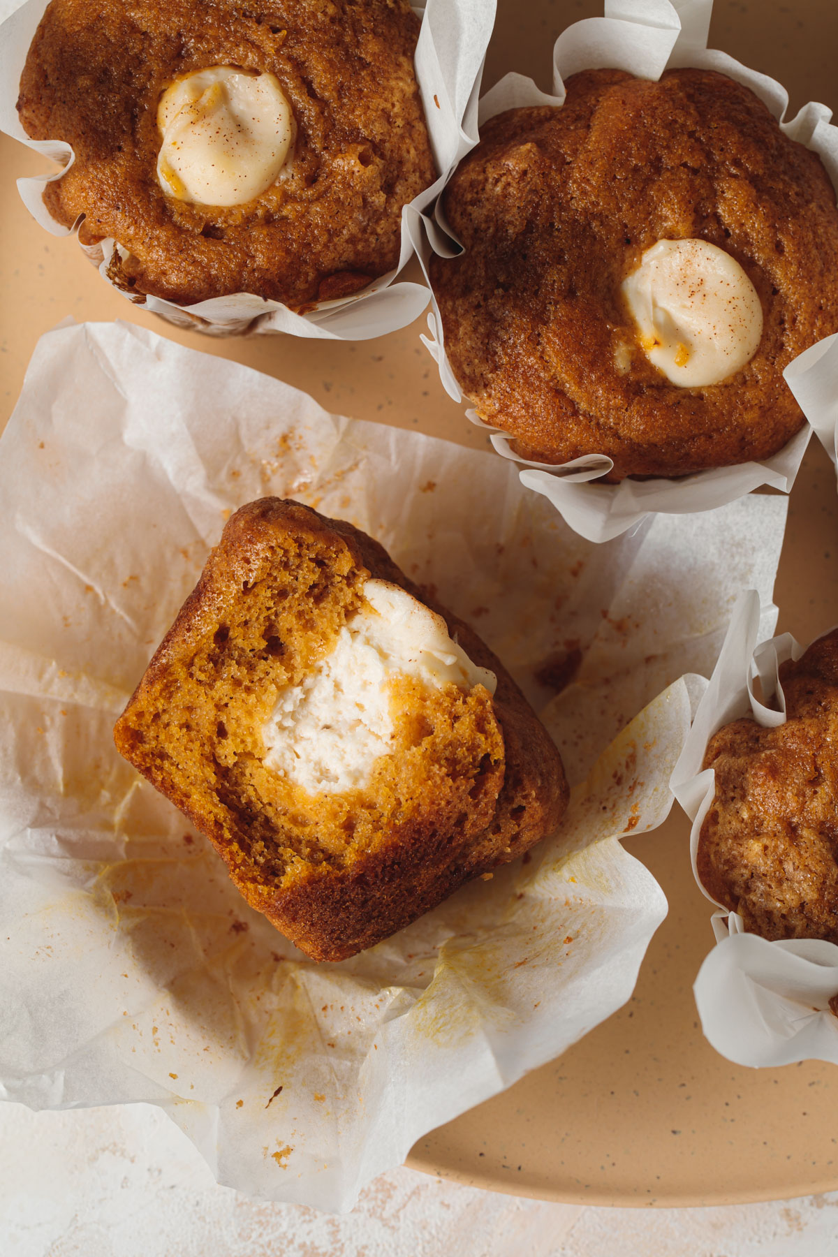 The inside of a pumpkin cream cheese muffin