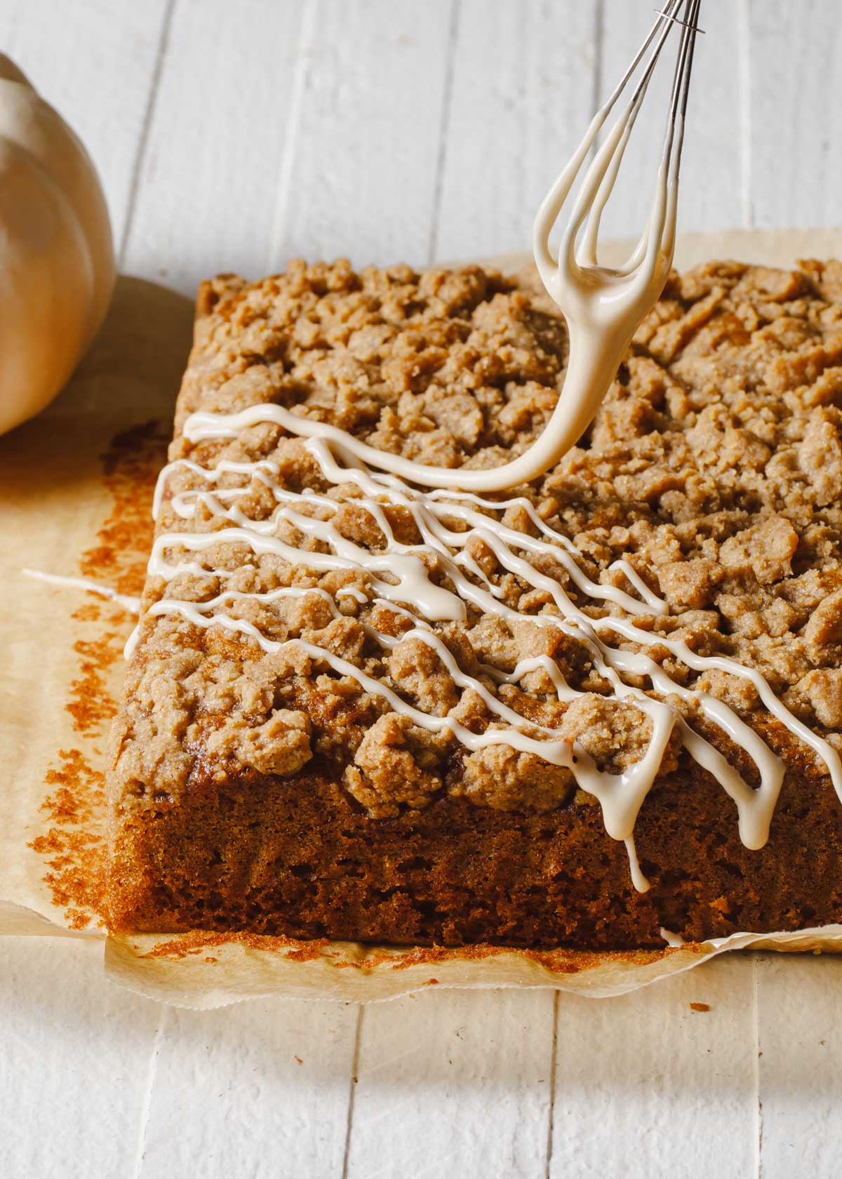 A drizzle of glaze on top of a coffee cake