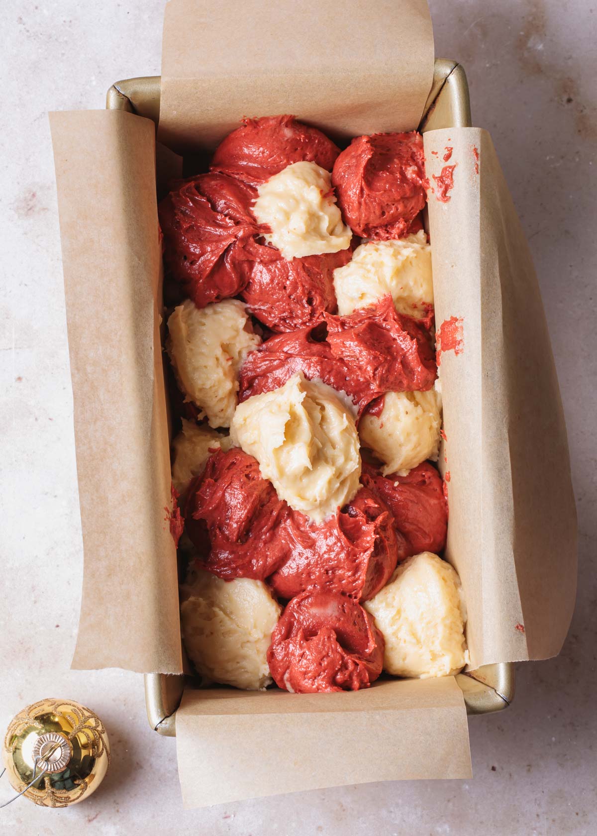 Red velvet pound cake batter in a loaf pan