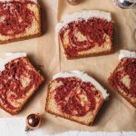 An overhead view of slices of red velvet marble cake with vanilla icing