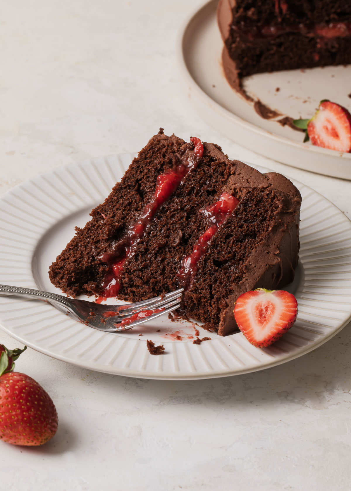 A slice of chocolate strawberry cake on a plate