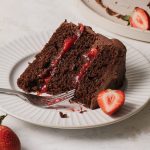 A slice of chocolate strawberry cake on a plate