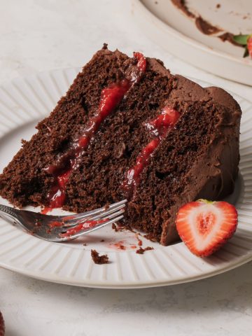 A slice of chocolate strawberry cake on a plate