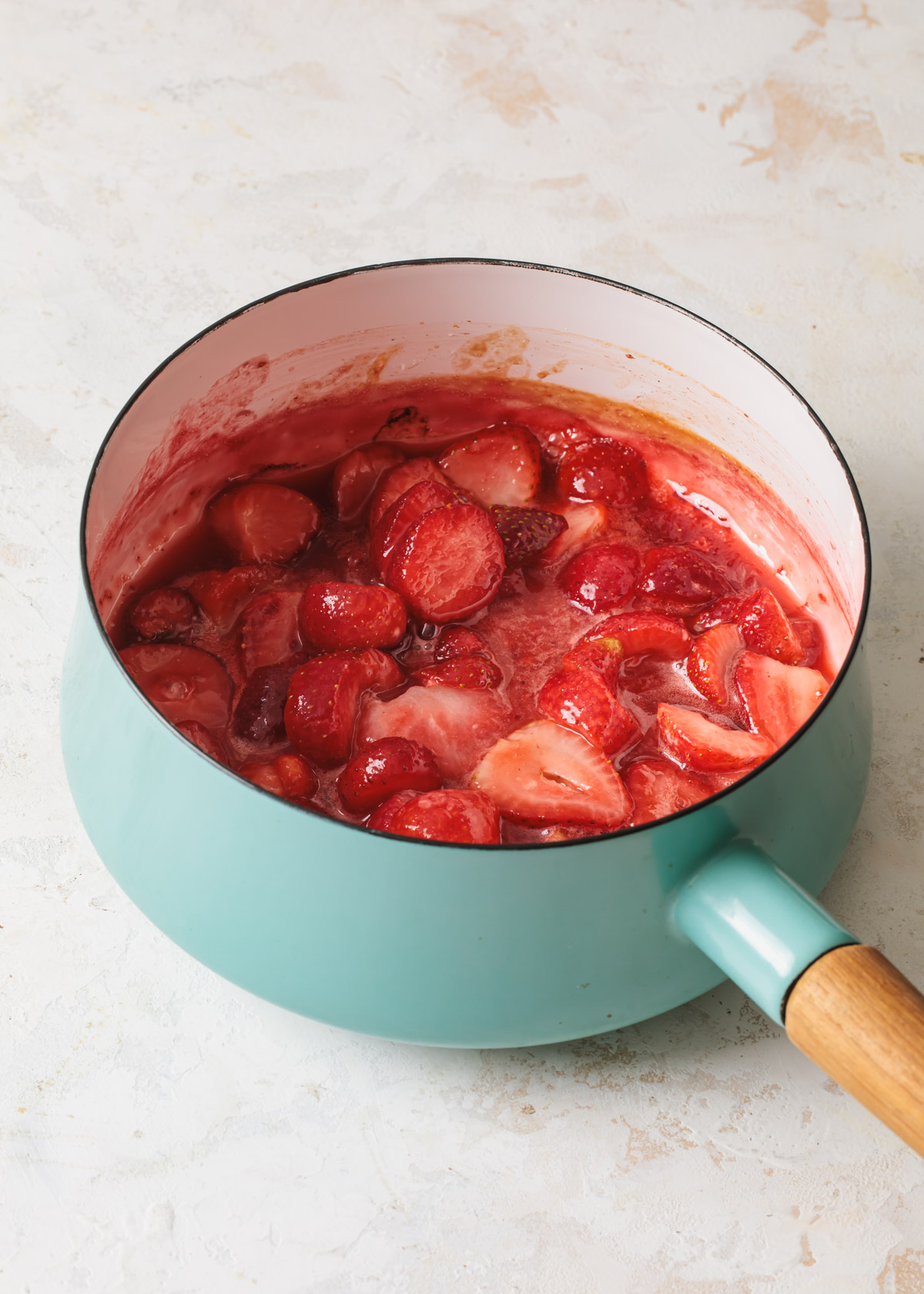 Strawberries cooking in a pot to make sauce
