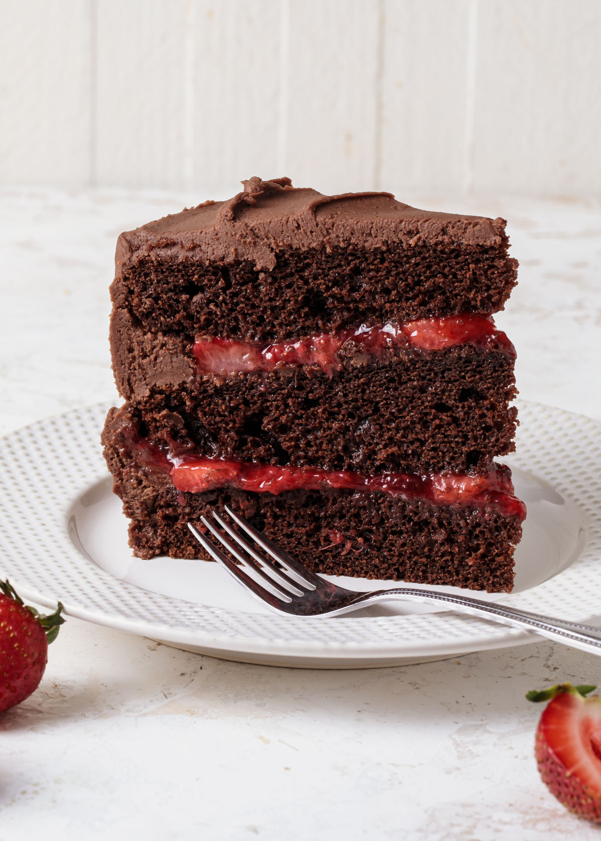 A chocolate layer cake with strawberry cake filling