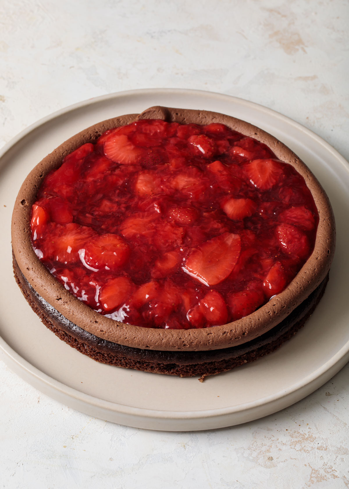 Building a chocolate cake with strawberry filling