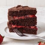 A slice of chocolate cake with strawberry filling