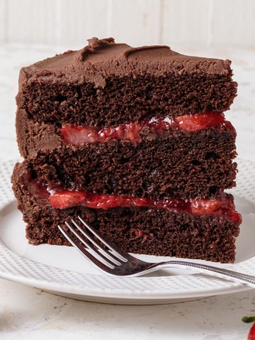 A slice of chocolate cake with strawberry filling
