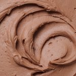 Close up of milk chocolate buttercream frosting swirls