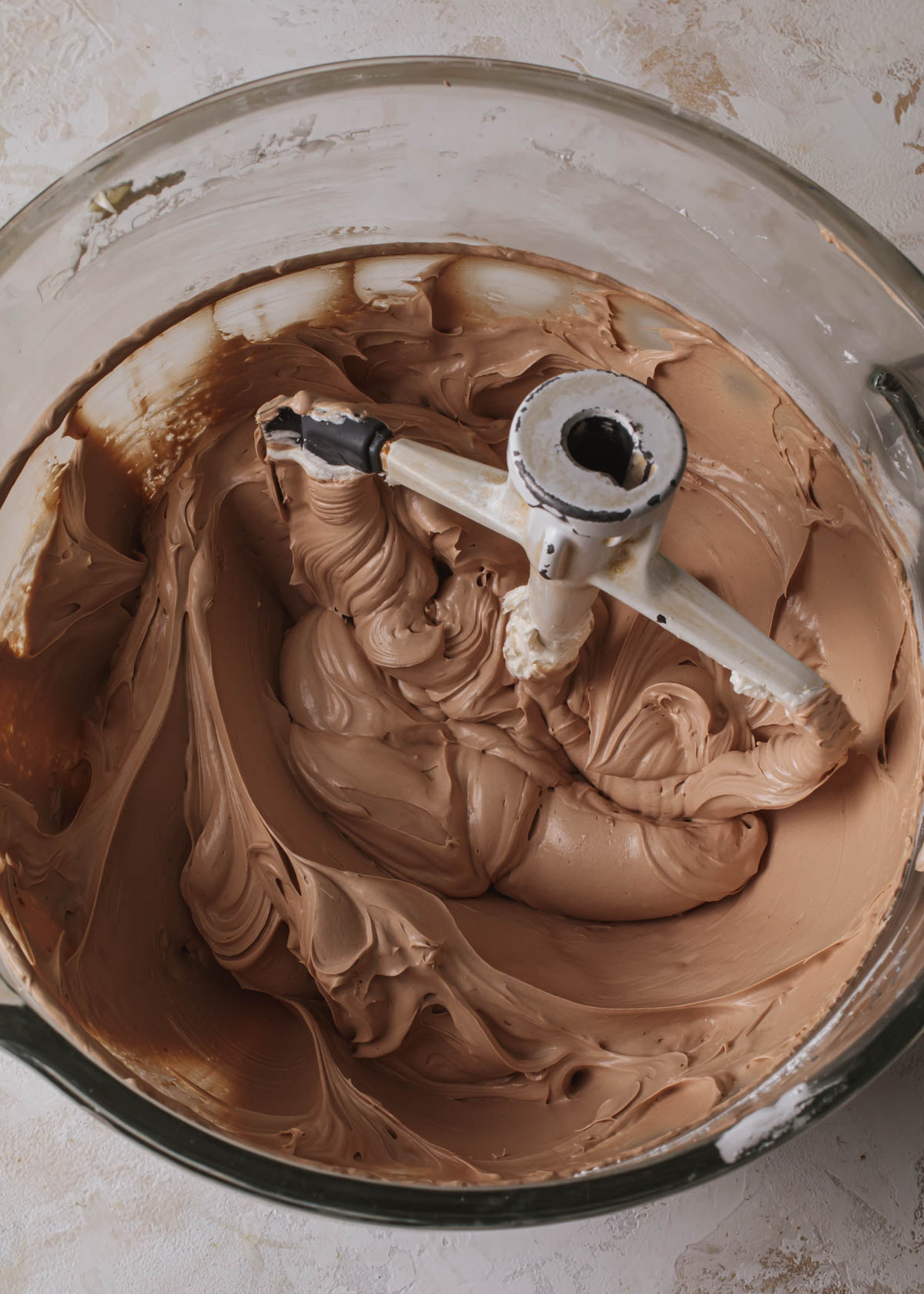 A mixing bowl of creamy chocolate Swiss meringue buttercream